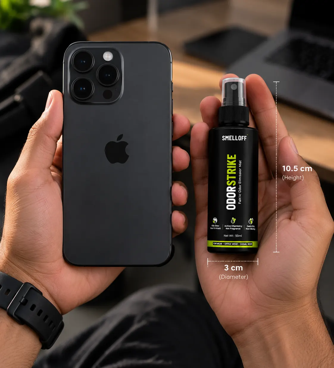 ODORSTRIKE held in one hand next to a smartphone in the other: 10.5 cm tall, 3 cm across, smaller than the phone