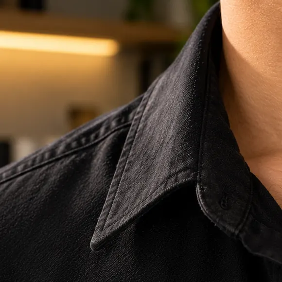 The same black shirt collar after spraying, dried clear.
