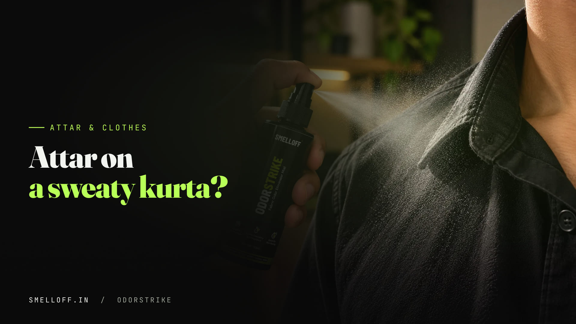 A fine mist from a small spray bottle lands on the collar of a black shirt, on the fabric not the skin