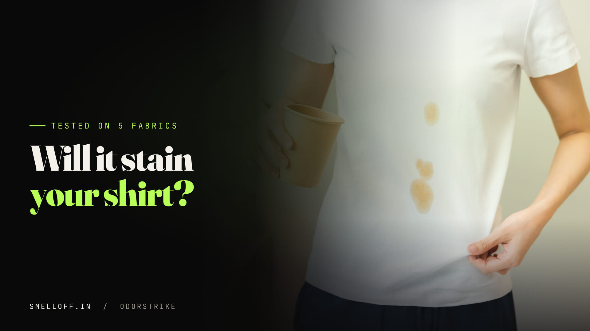 A person holds out a white t-shirt marked with fresh stains to check whether a spray leaves a residue