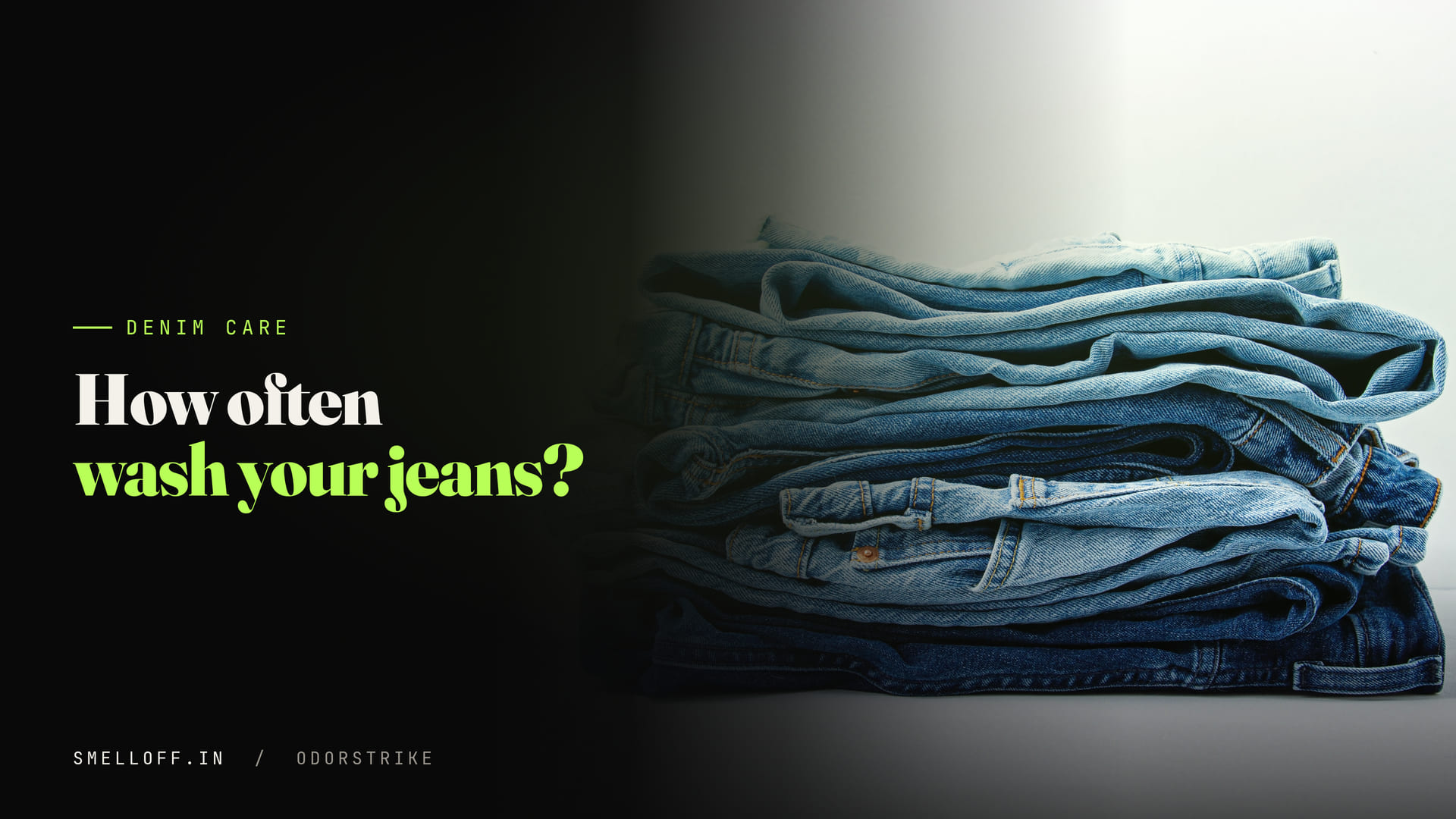A neat stack of folded blue denim jeans in several washes against a pale background