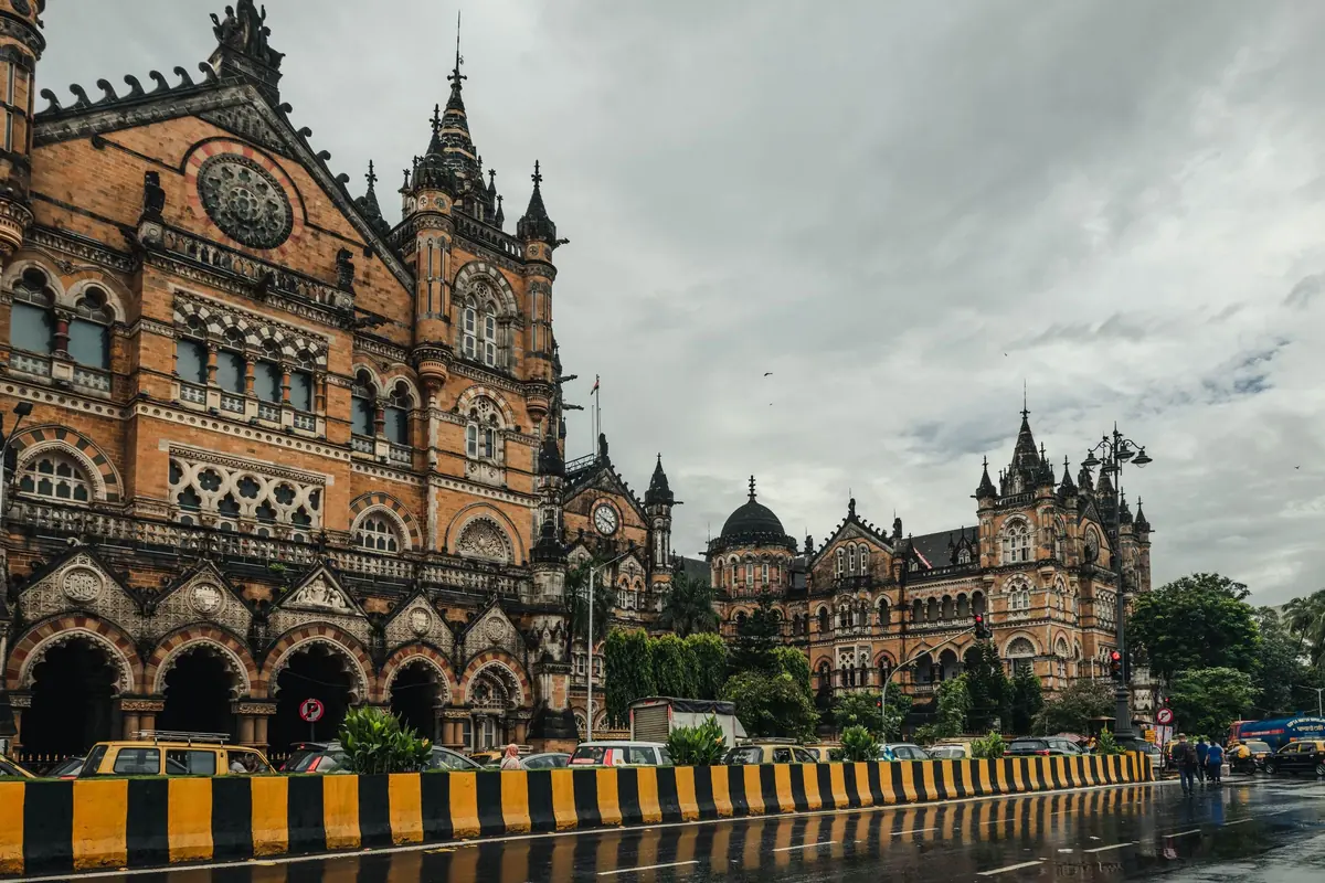 Mumbai’s Chhatrapati Shivaji Terminus under heavy monsoon clouds, the road wet