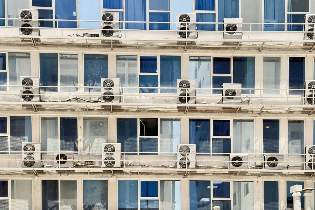 An office building facade lined with rows of air-conditioner units