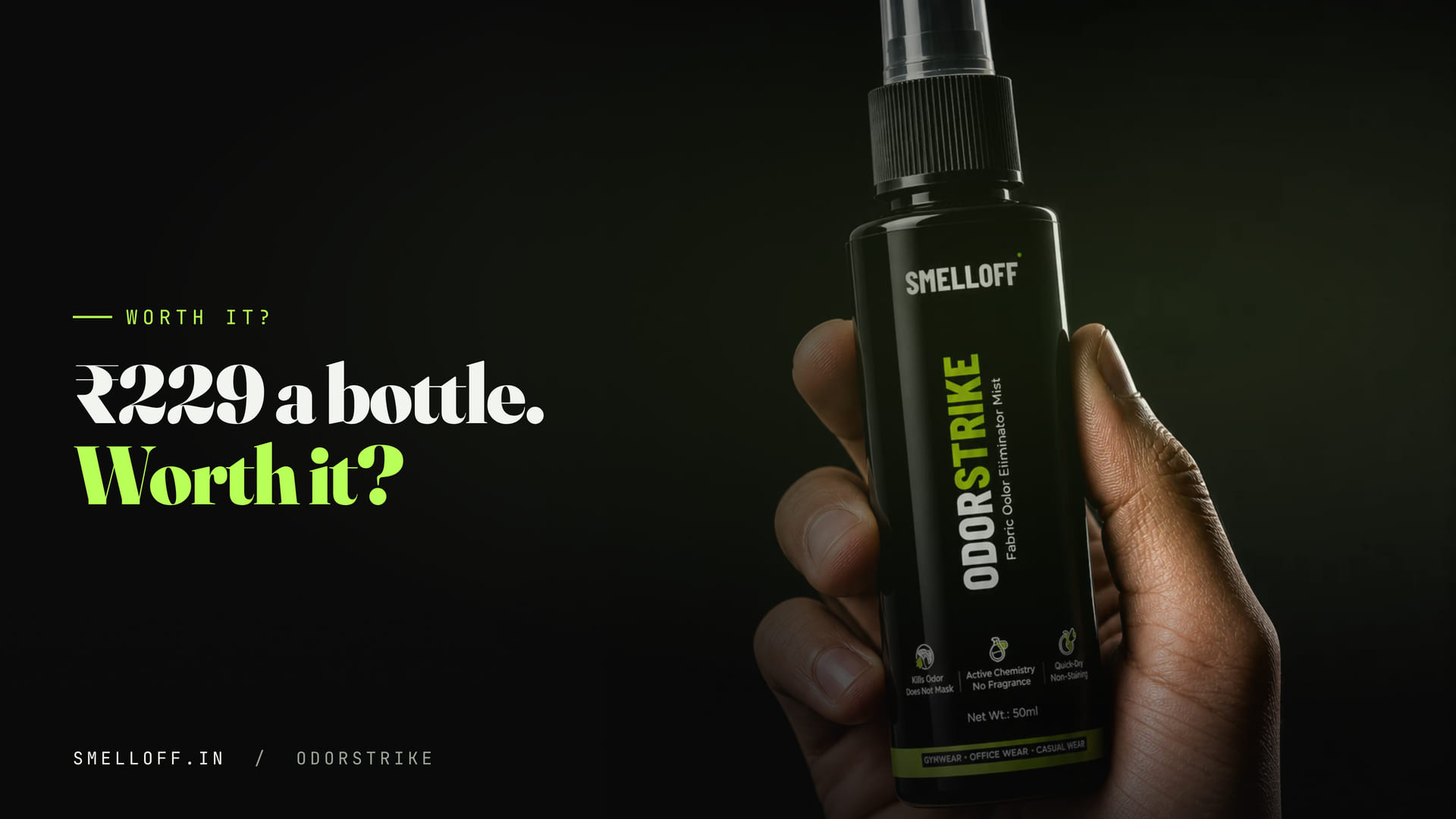 A hand holds the ODORSTRIKE 50ml fabric odor spray bottle against a black background
