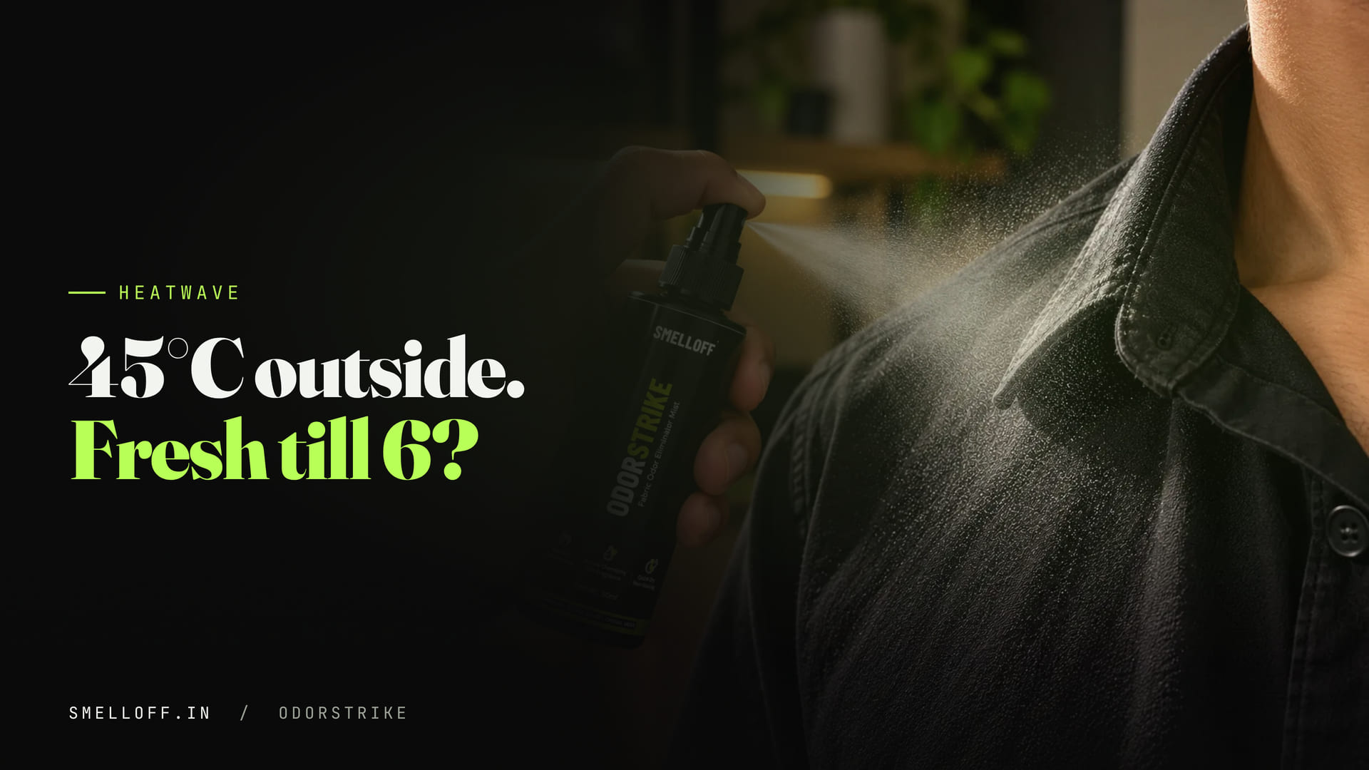 The ODORSTRIKE bottle mists the collar of a black shirt